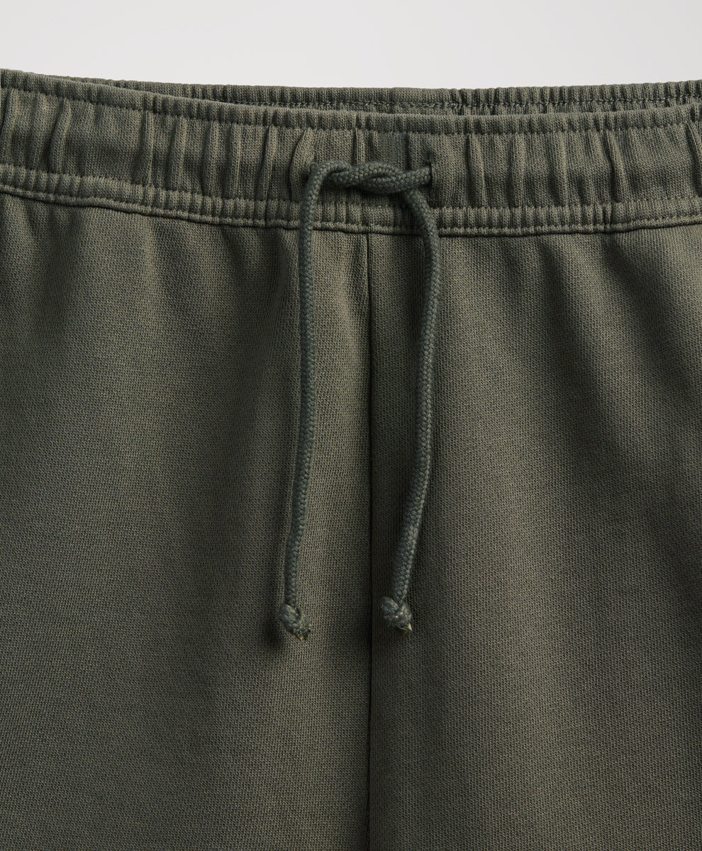 close up of pact dusted green sweatpants elastic waist and drawtring.