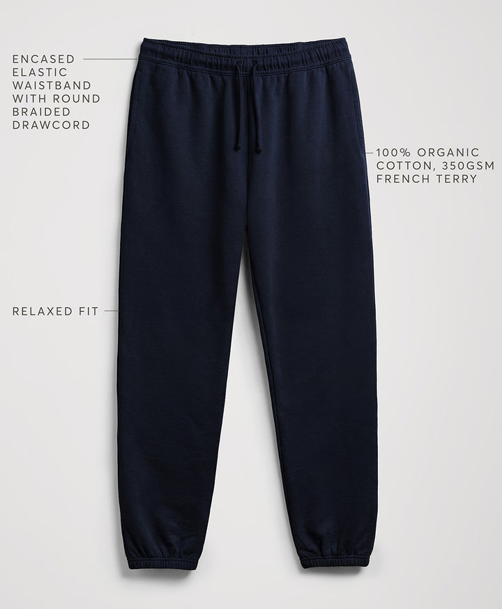 Navy blue jogger sweatpants with text callouts highlighting features like the enclosed elastic waistband, relaxed fit, and cotton fabric, shown on a light gray background.