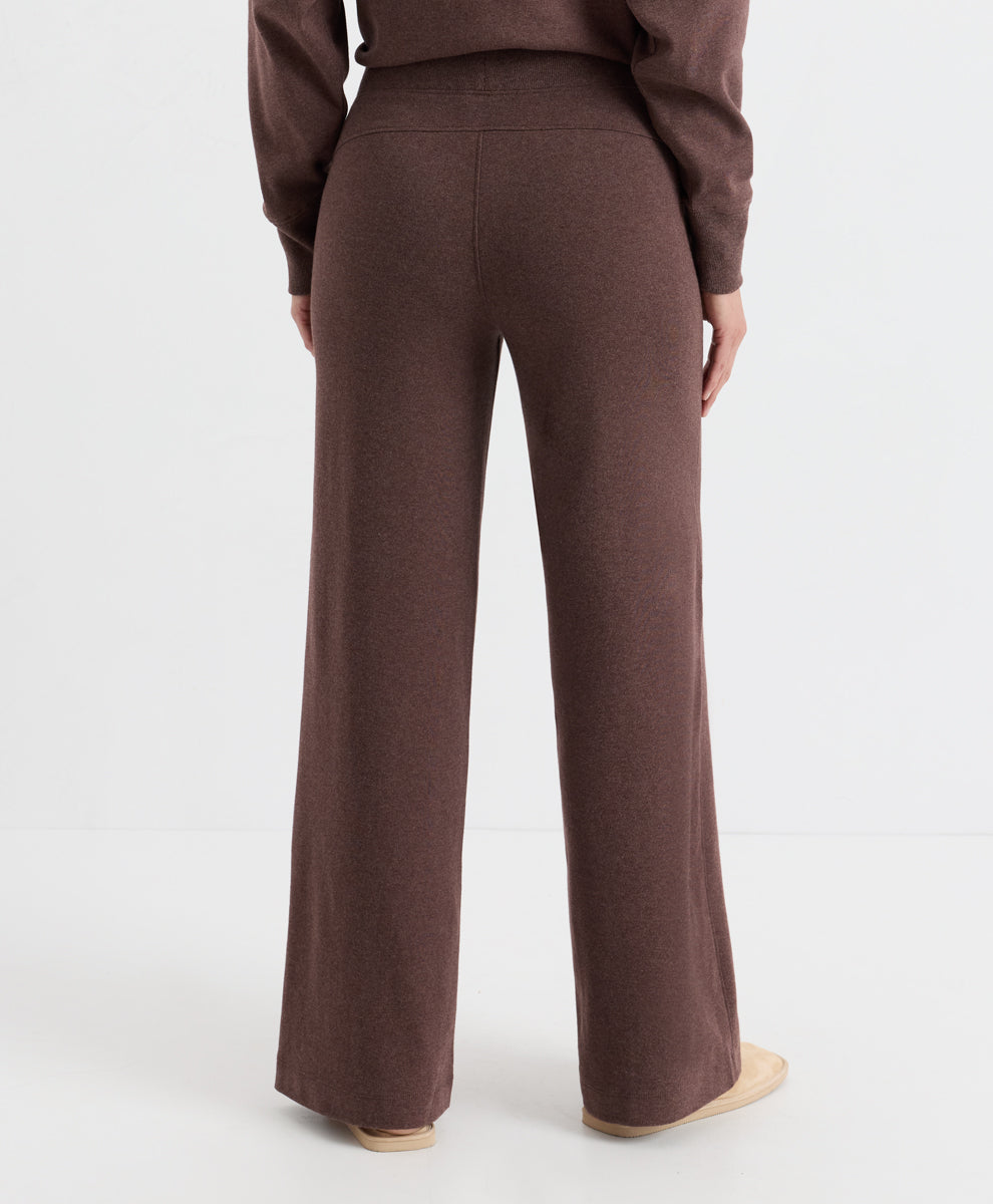 A person shown from the back wearing a matching chestnut heather knit top and wide-leg knit pants, photographed against a clean light gray studio background.