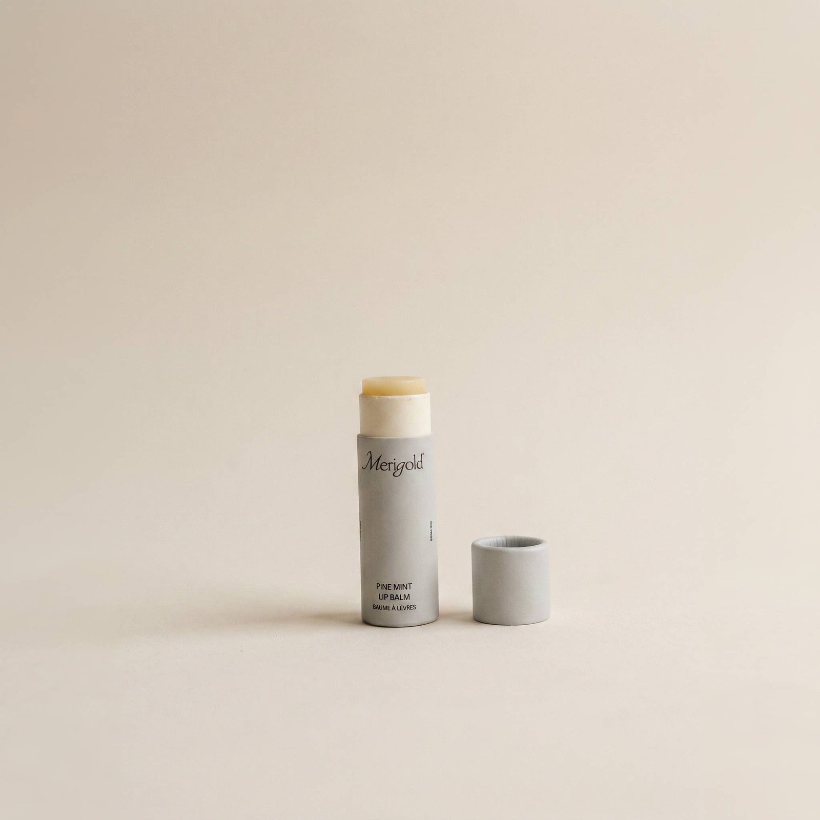 Lip balm and container on a beige background