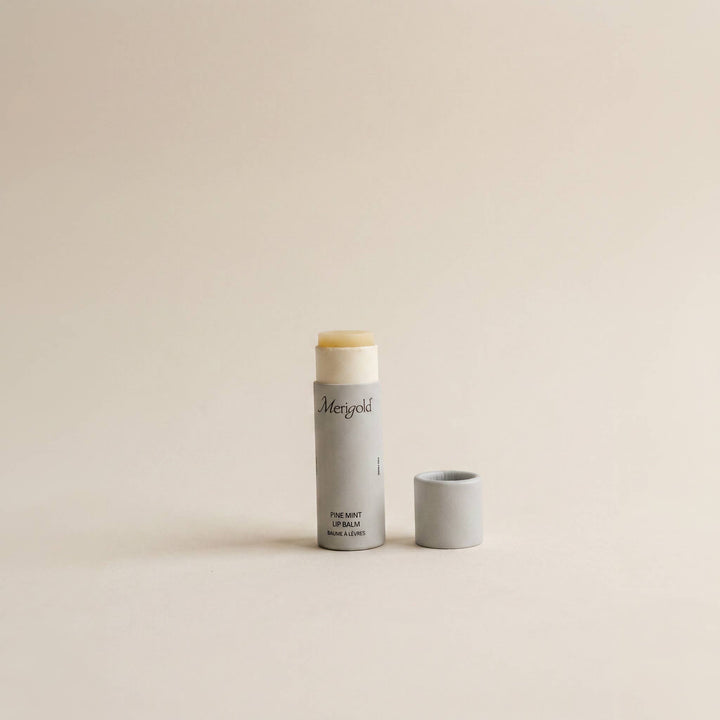 Lip balm and container on a beige background