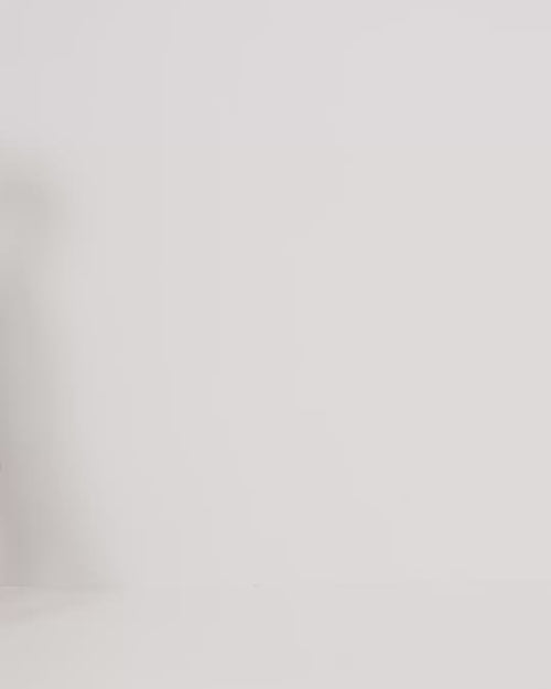 Woman wearing Pact's Organic Coastal Double Gauze Curved Hem Short in cream on a white background