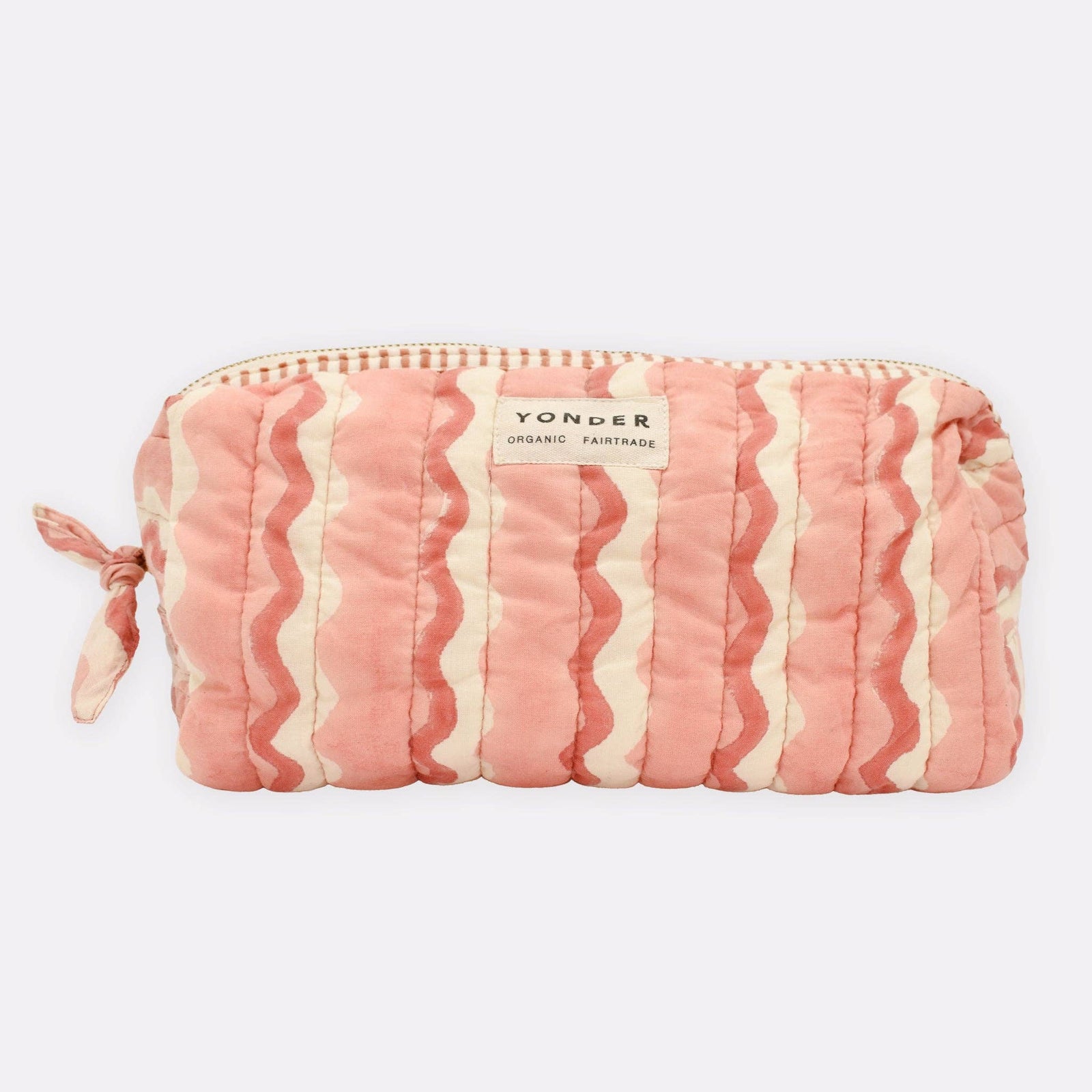 Pink and white striped pouch with 'Yonder' branding on a light pink background
