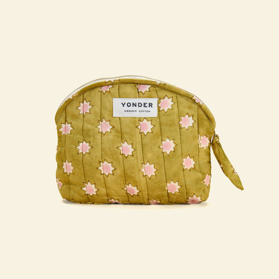 A quilted cosmetic pouch in olive green with a pink star pattern, featuring a white Yonder brand label on the front.