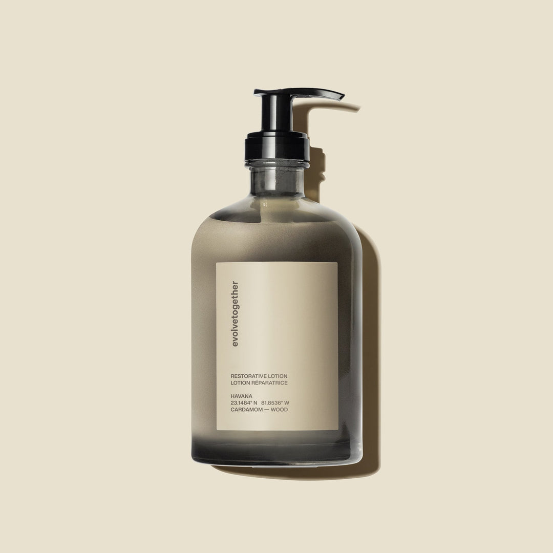 Clear evolvetogether restorative lotion glass bottle with pump on a beige background