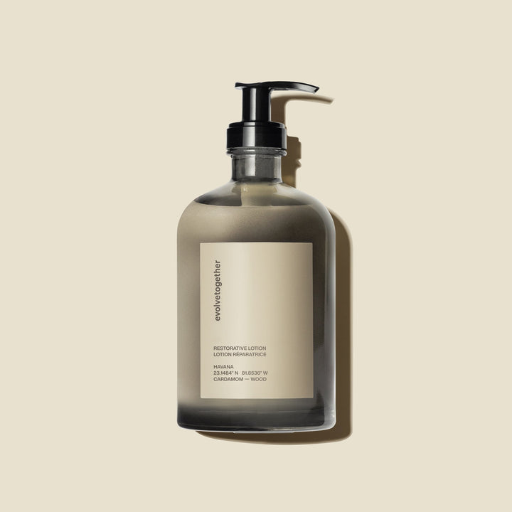Clear evolvetogether restorative lotion glass bottle with pump on a beige background