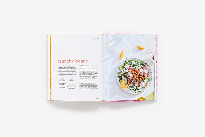 Open cookbook showing a page with a salad recipe and ingredients.