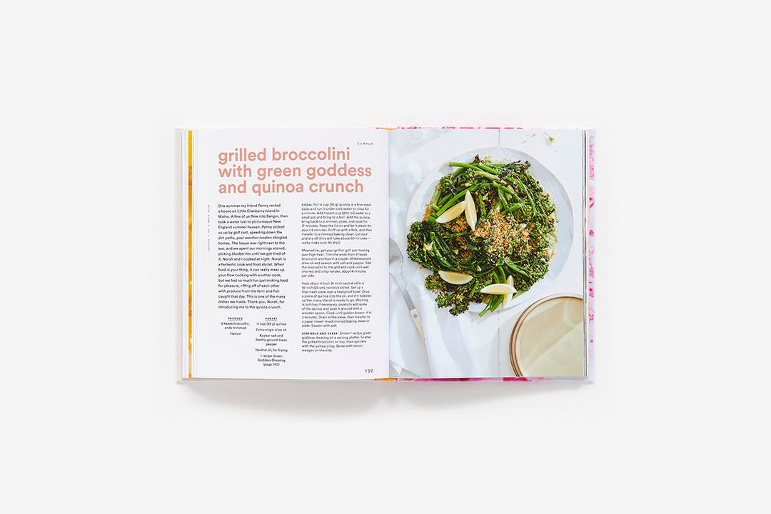 Open book showing a recipe for grilled broccoli with quinoa on a white background