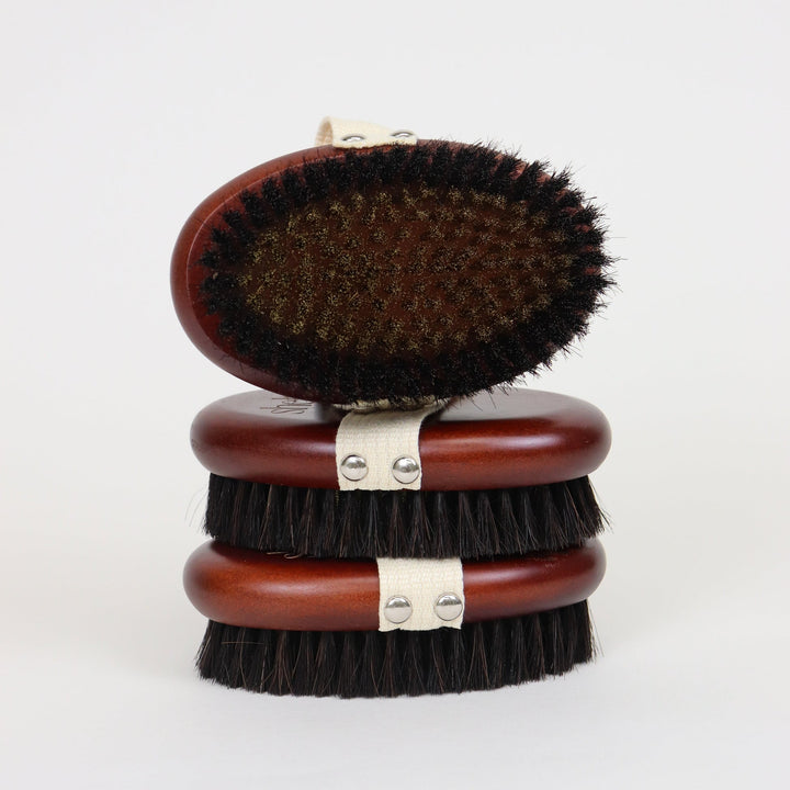 Stack of three Shelter Skin Sculpting Copper Dry Brushes on a white background.
