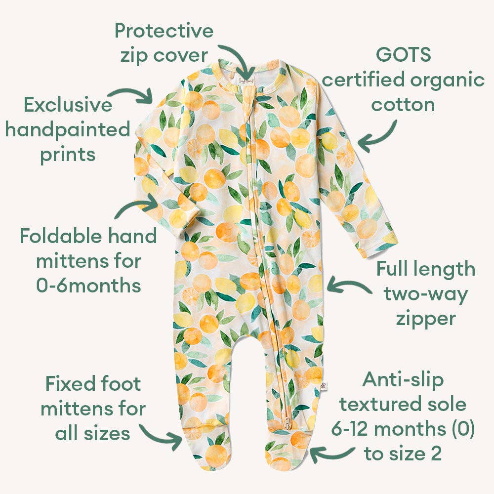 Baby onesie with lemon pattern and features listed on a white background