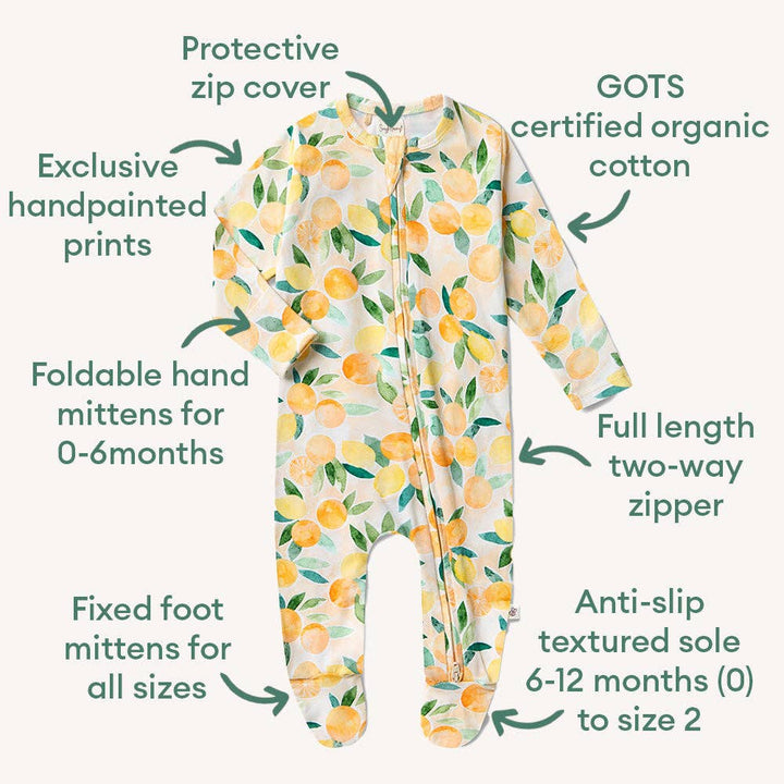 Baby onesie with lemon pattern and features listed on a white background