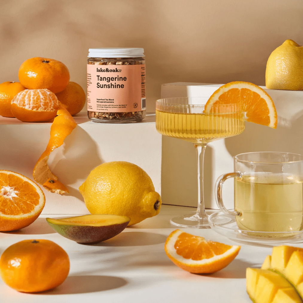 Fruits and a jar labeled 'Tangerine Sunshine' on a light background