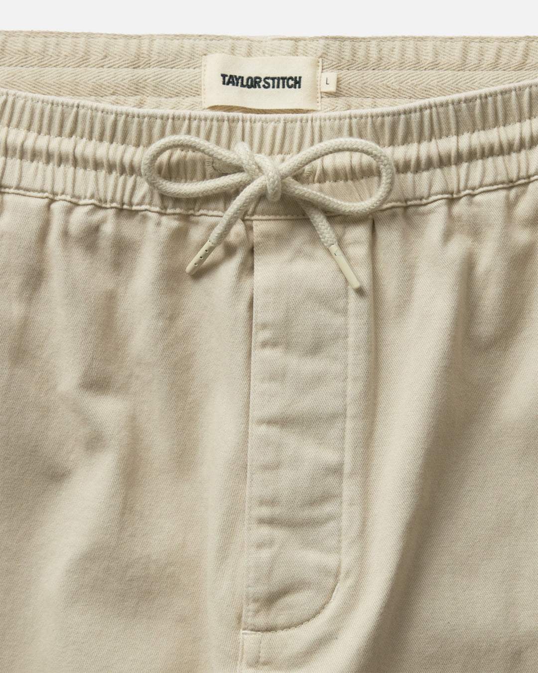 Taylor Stitch The Après Short in Organic Aged Stone Foundation Twill with drawstring on a white background