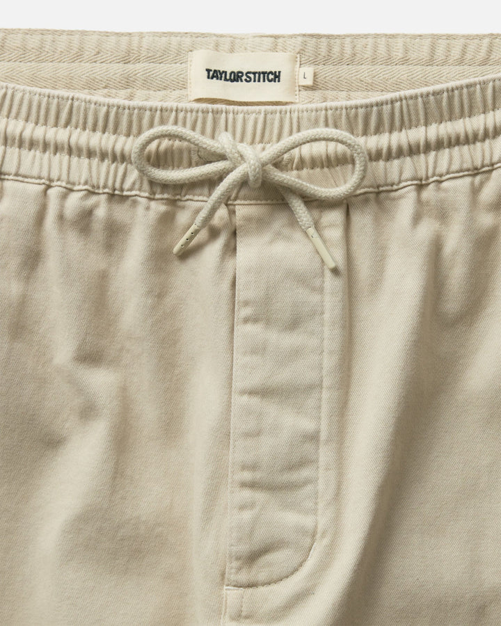 Taylor Stitch The Après Short in Organic Aged Stone Foundation Twill with drawstring on a white background