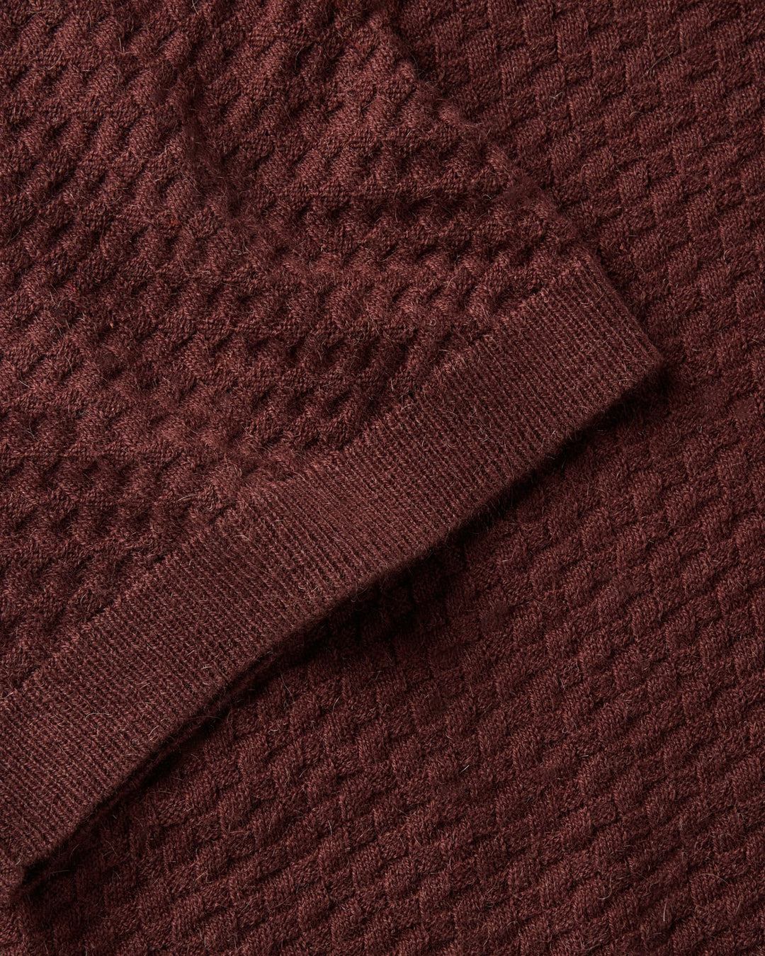 Close-up of The Arlo Sweater Polo
in Burgundy Texture Knit textured fabric with a pattern
