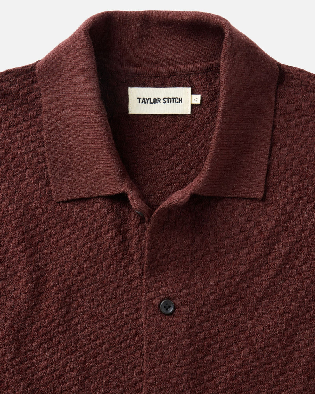 The Arlo Sweater Polo
in Burgundy Texture Knit with a visible Taylor Stitch label on a light gray background