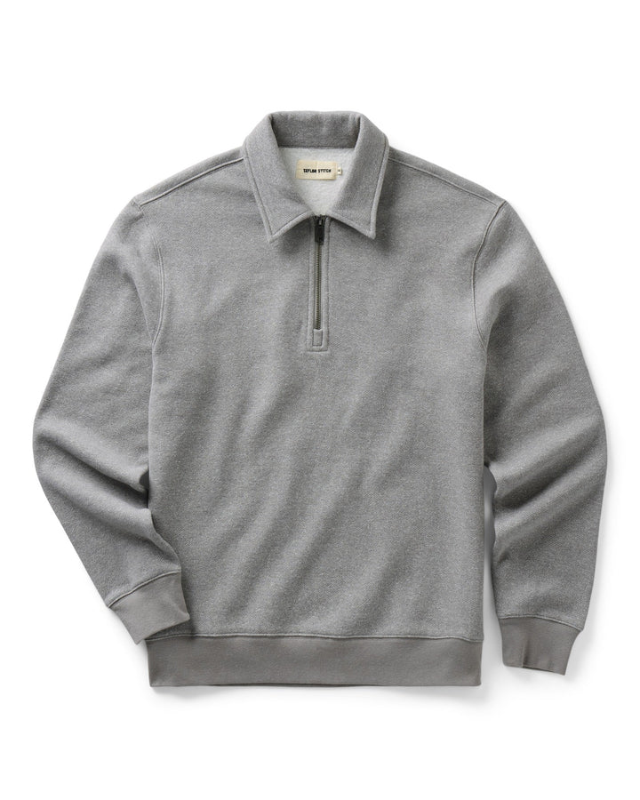 A light gray heathered quarter-zip pullover sweatshirt with a collar, shown flat against a white background.