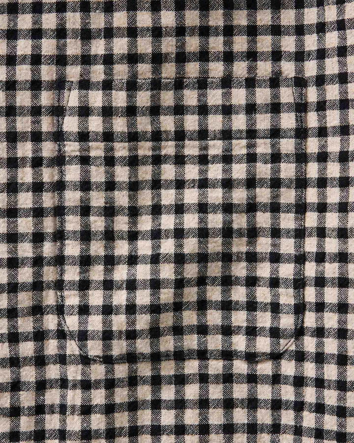 Close-up of The California Shirt in Breaker Gingham fabric with a single curved welt pocket stitched into the lower left area.
