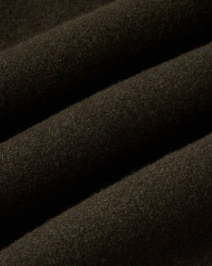 Close-up of the fabric of carnegie pants in Army wool. 