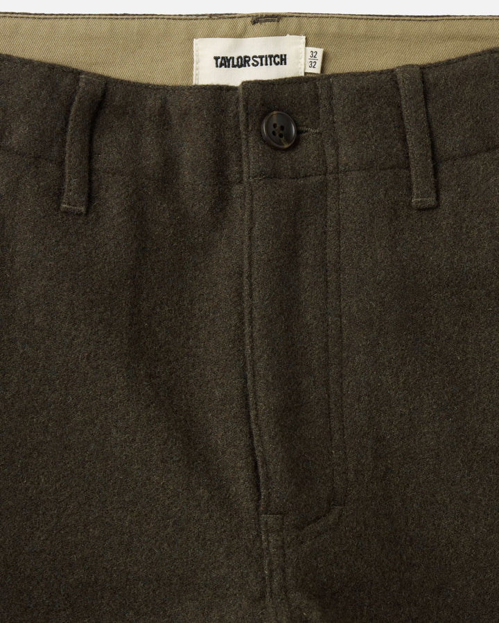 Close up of the front of the carnegie pants, button/zipper closure and Taylor Stitch tag.