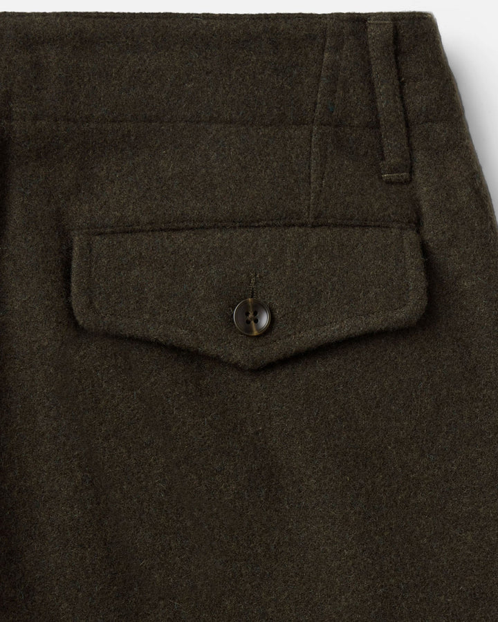 Close up of the back of the carnegie pants, showing right back pocket with button closure  and belt loop.
