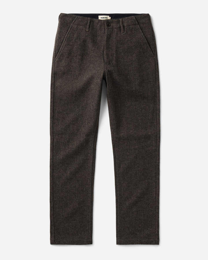 A pair of The Carnegie pants in Walnut Herringbone Wool, shown flat against a light gray background.