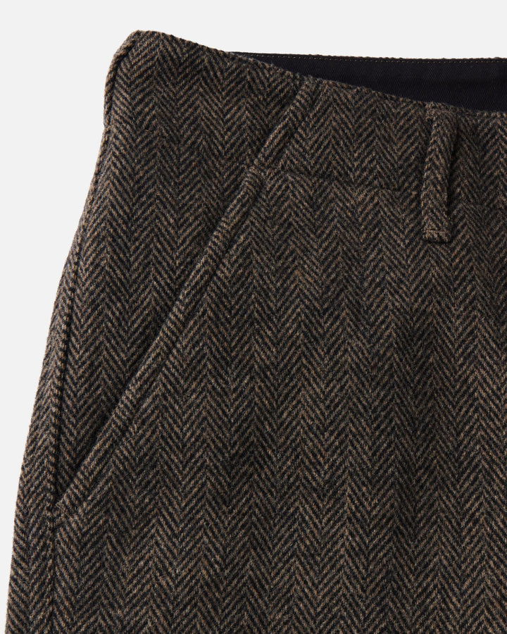 Close-up of The Carnegie Pant
in Walnut Herringbone Wool, showing the waistband, belt loop, and side pocket.