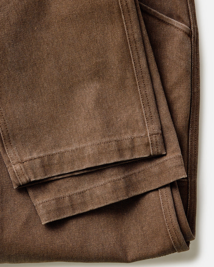 Folded Taylor Stitch Chore Pant in Aged Penny Chipped Canvas on a white background
