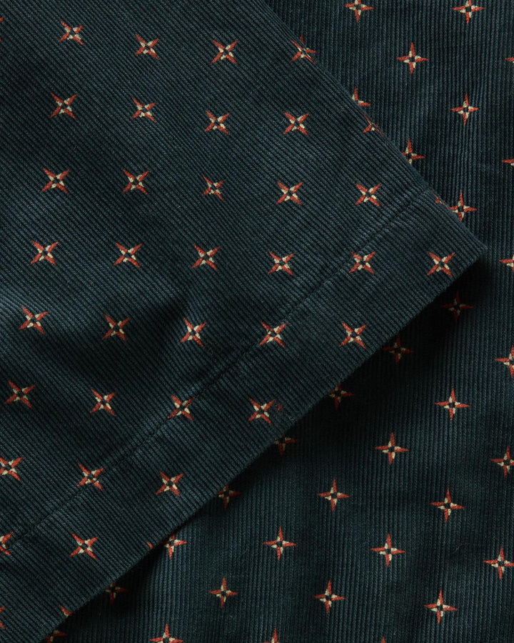 Dark fabric with small red floral patterns