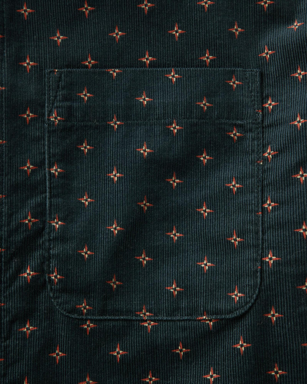 Dark fabric with small red star pattern