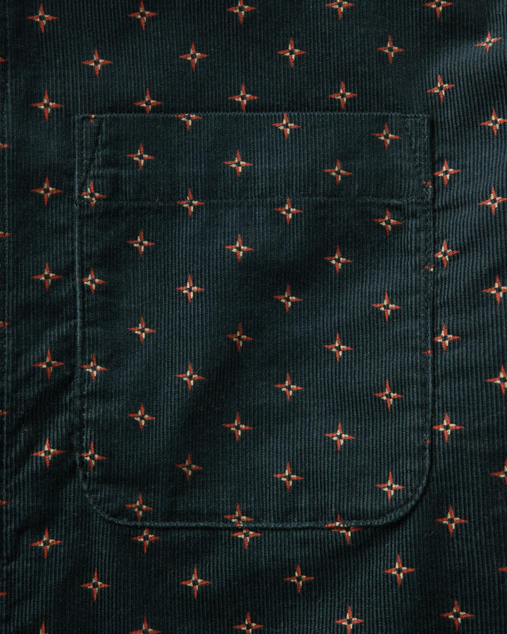 Dark fabric with small red star pattern
