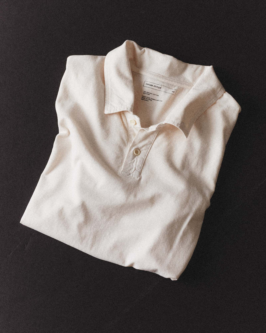 Folded Cotton Hemp Polo in Vintage White by Taylor Stitch on a black background