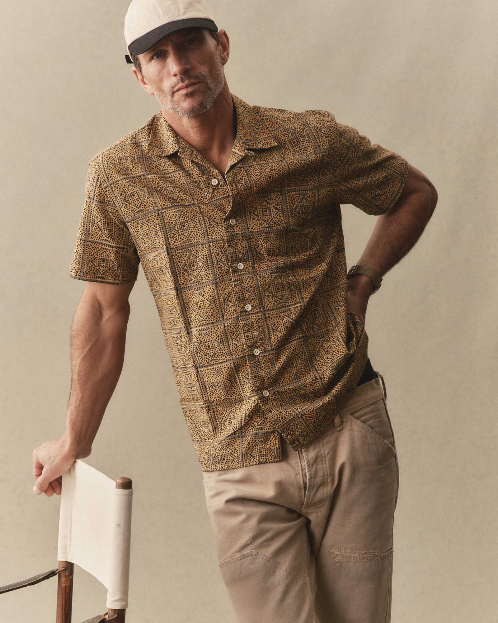 Man wearing The Hawthorne Shirt
in Fennel Block Print and beige pants against a plain background