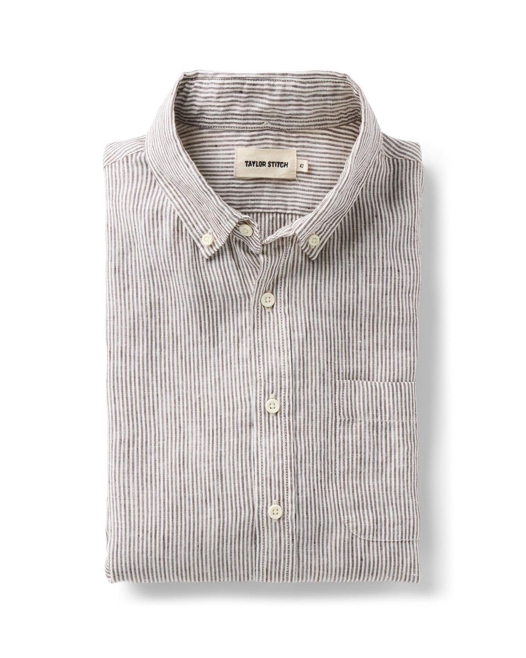Folded burgundy and white striped shirt with button details on a white background