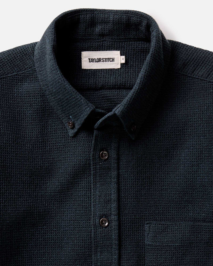 Close-up of The Jack Shirt in Forest Waffle by Taylor Stitch, showing the collar, snap buttons, and fabric weave against a light background.