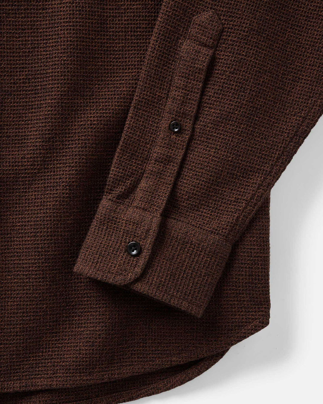 Close-up of The Jack Shirt in Timber Twist Waffle with a buttoned cuff, showing the fabric weave and button details against a light background.