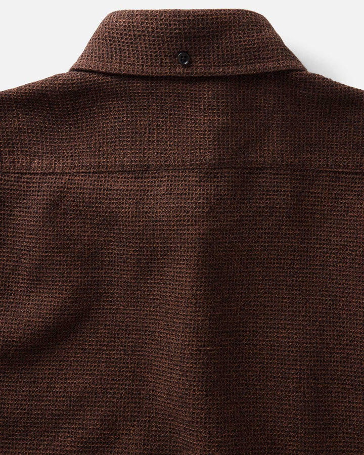 Close-up of the back collar and upper back of The Jack Shirt in Timber Twist Waffle, showing a single dark button at the collar on a light neutral background.