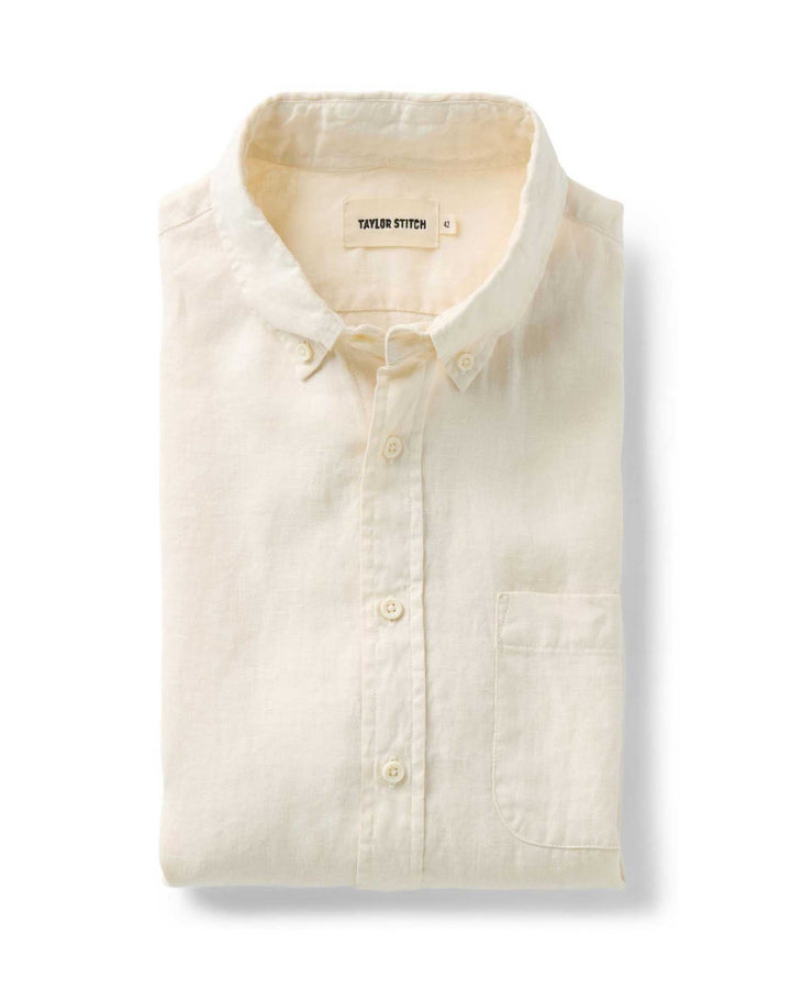 Folded Vintage white-colored shirt with a Taylor Stitch label on a white background