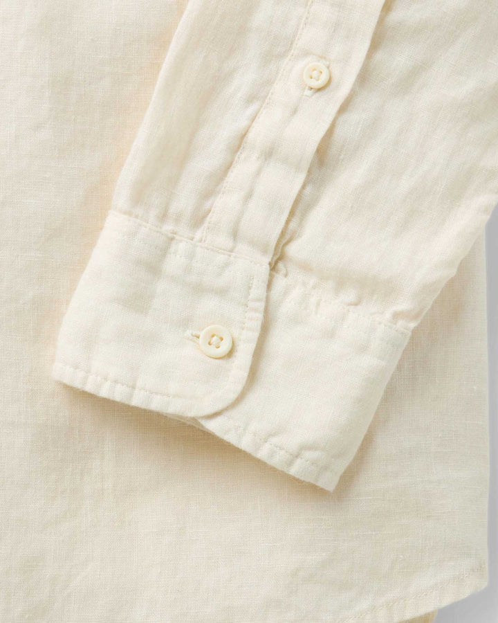 Close-up of a vintage white-colored shirt with buttons on a light background