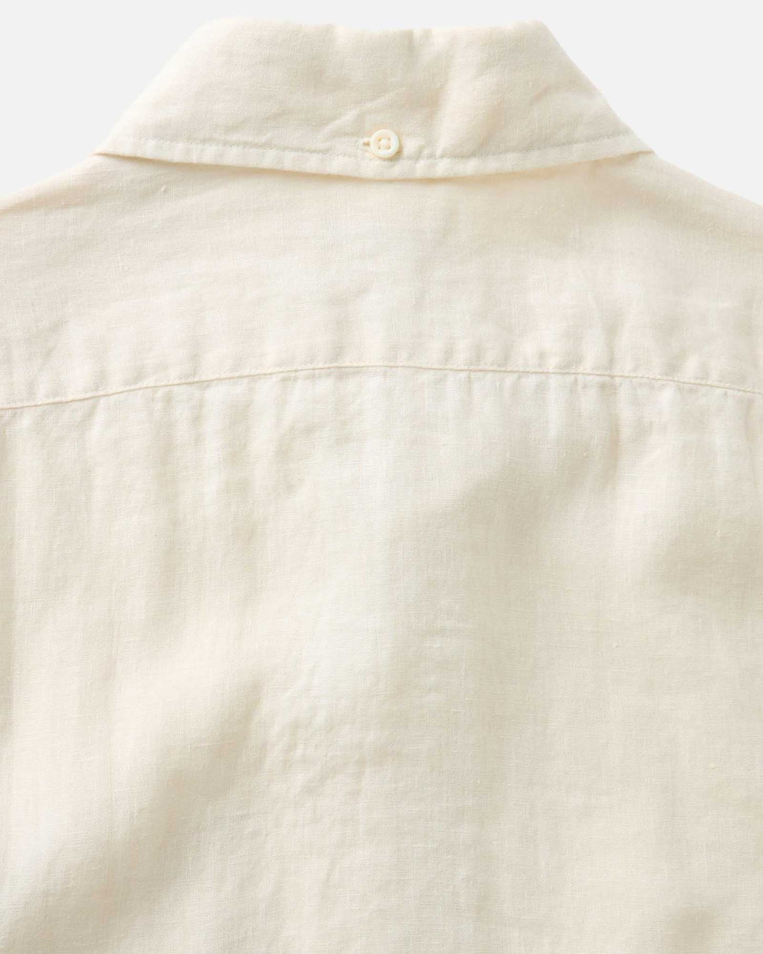 Close-up of a vintage white-colored shirt collar and sleeve on a white background