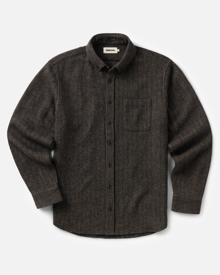A dark brown textured long-sleeve button-up shirt with a chest pocket, displayed flat against a light gray background.