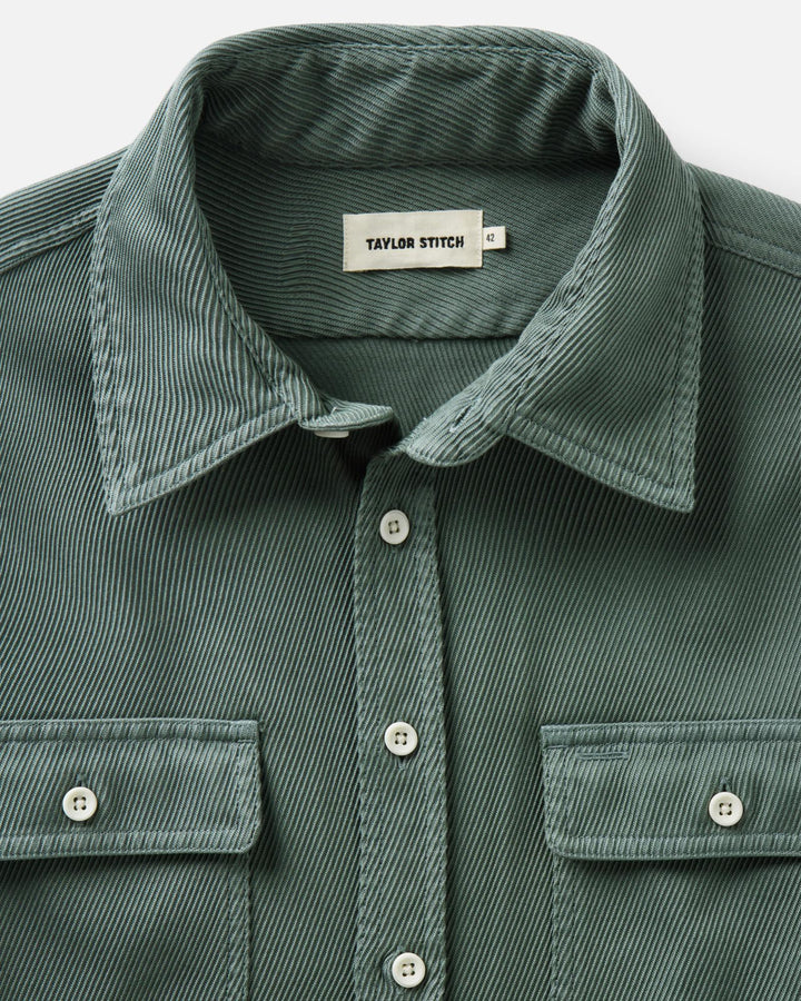 Close-up of a deep sea ledge button-up shirt by Taylor Stitch, showing the collar, front buttons, and chest pockets.