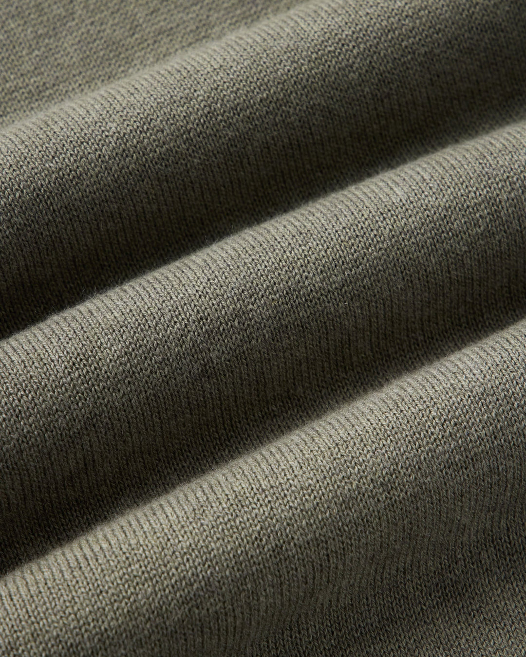 Close up of the valencia sweater fabric in olive cotton cashmere.