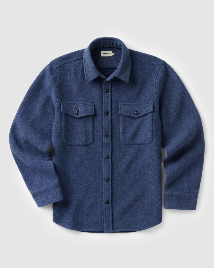 The Maritime Shirt Jacket
in Heather Navy Wool with two buttoned chest pockets, displayed flat against a light gray background.