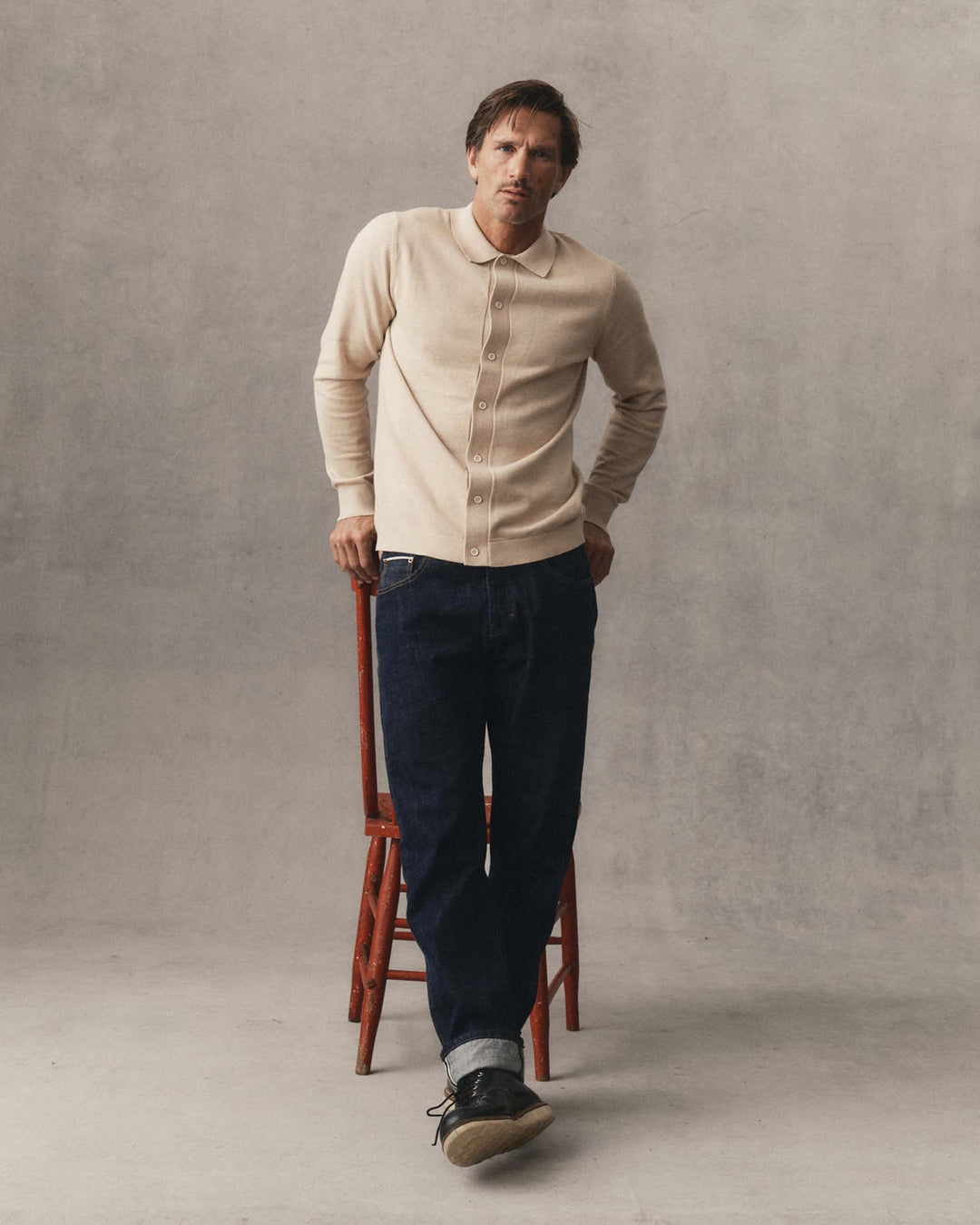 A man stands in a studio wearing Taylor Stitch&