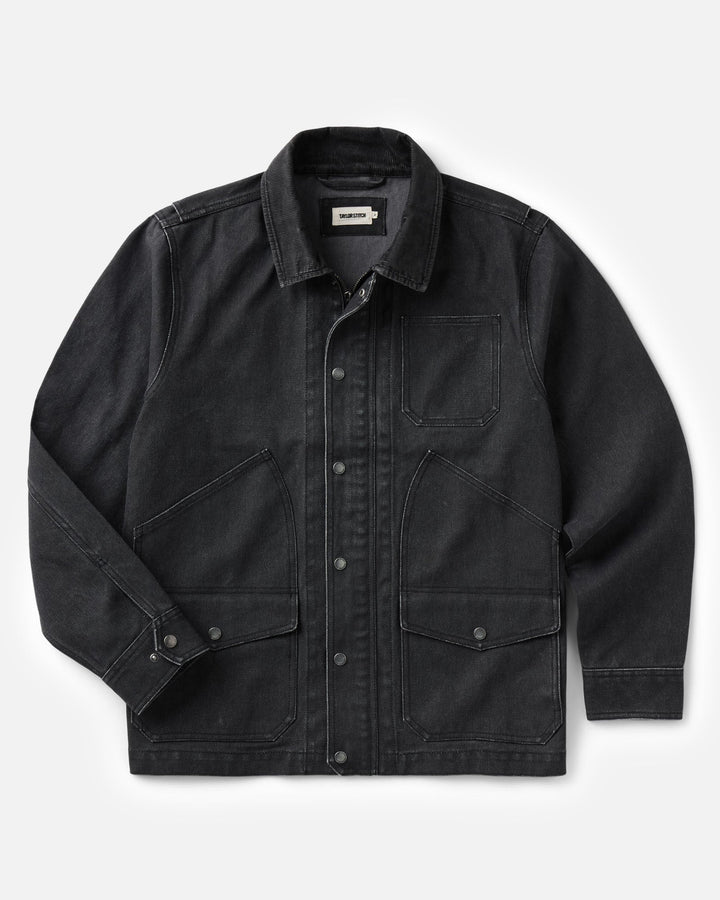 A coal denim jacket with a button-up front, collar, and four front pockets, displayed flat against a light gray background.