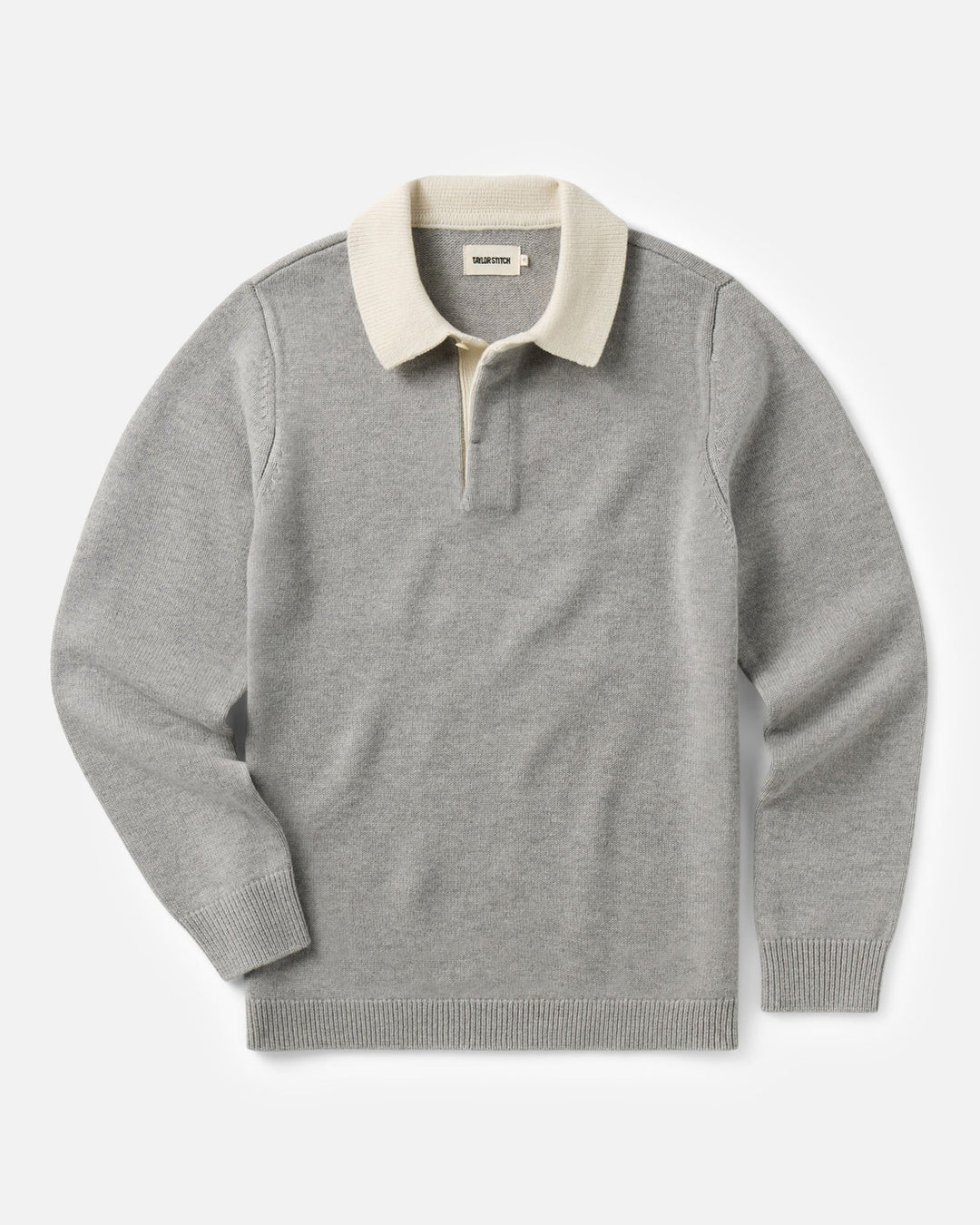 A light gray knit rugby sweater with a contrasting cream-colored collar and a short button placket, displayed flat against a light gray background.