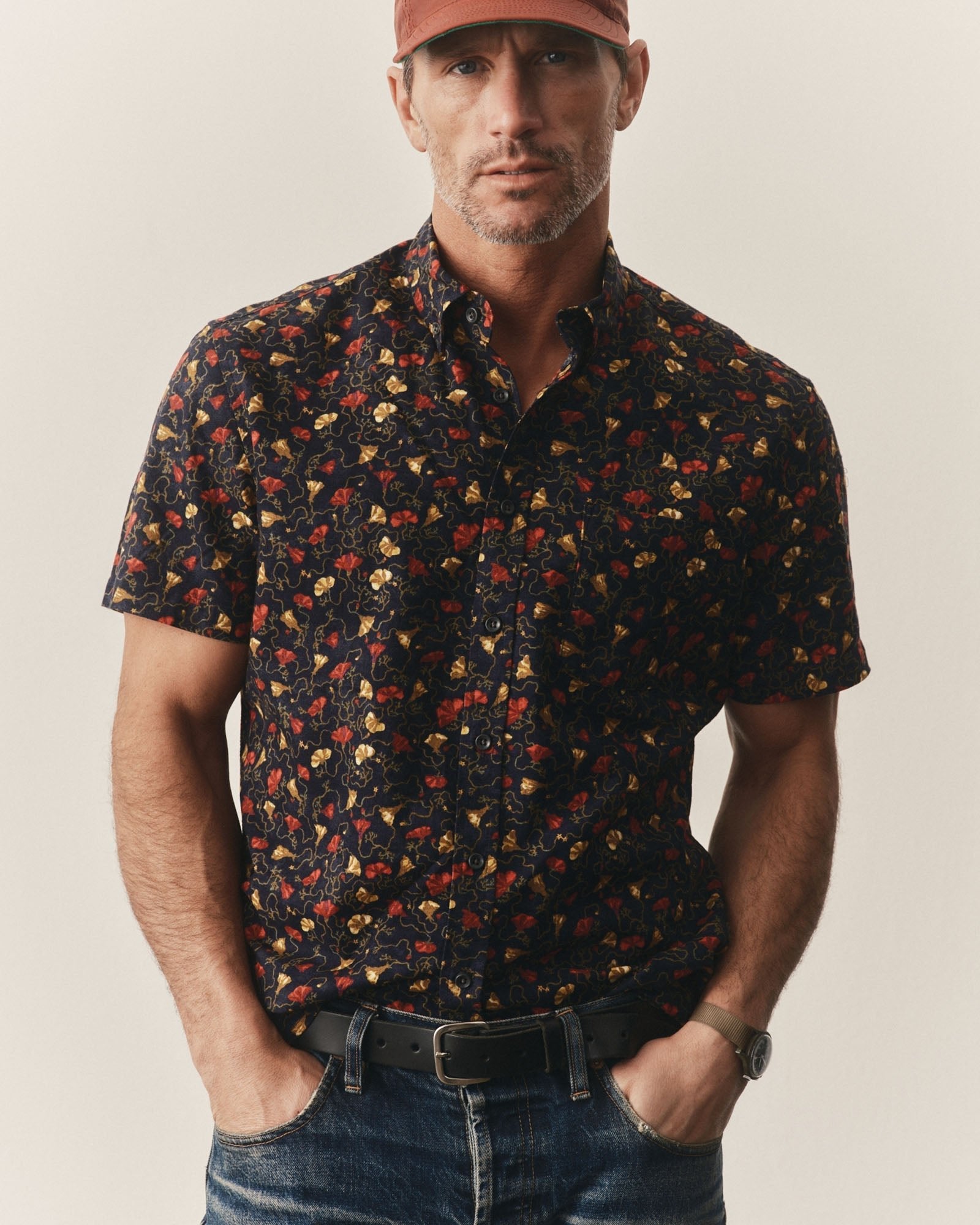 Man wearing The Short Sleeve Jack
in Vintage Bloom and jeans with a neutral background