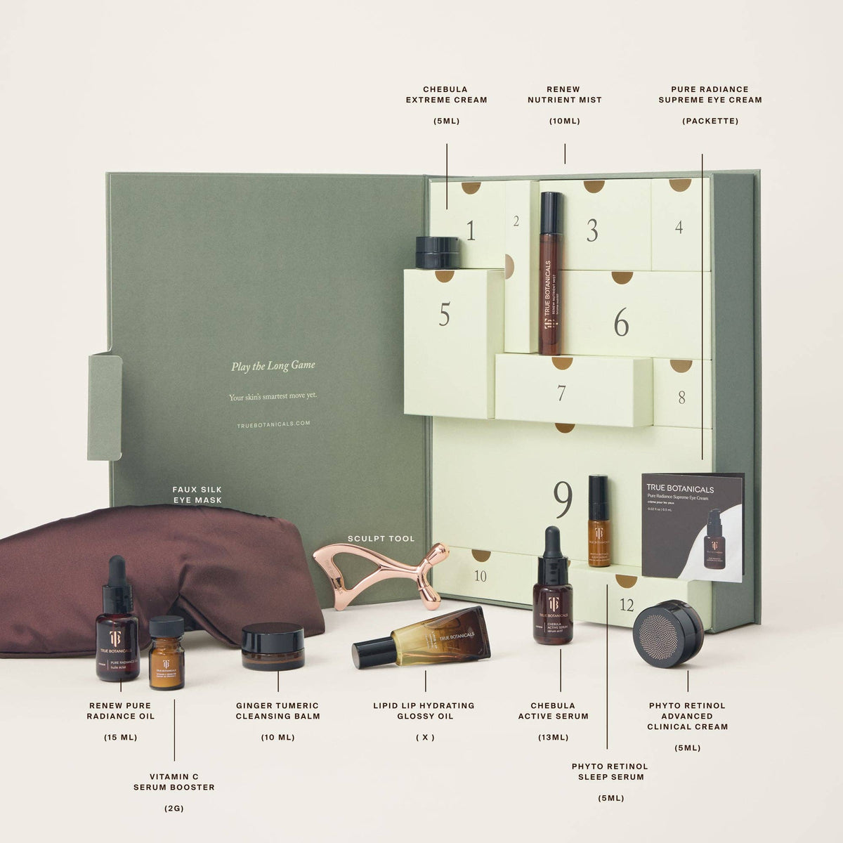 A True Botanicals skincare advent calendar set displayed on a light beige background, featuring a sage green and cream 12-compartment box with numbered drawers, multiple skincare bottles and jars, a brown eye mask pouch, and a rose gold sculpting tool. Text labels identify each item and its brand.