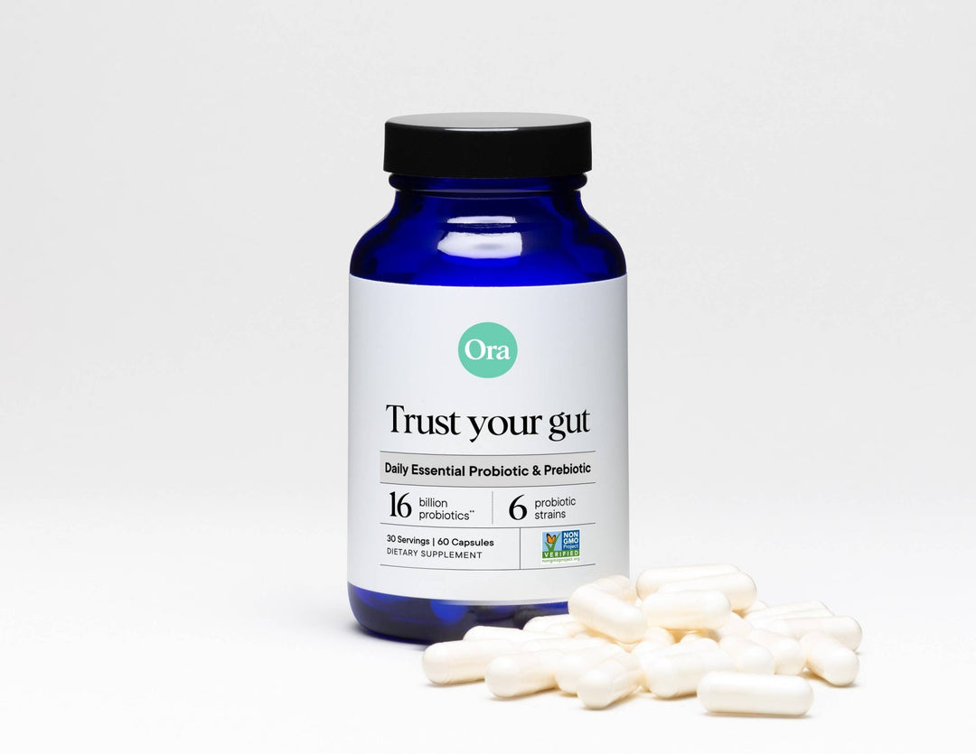 Ora probiotic supplement bottle with capsules on a white background